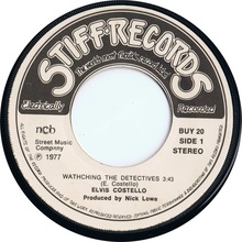 Vinyl 45-rpm of ’Watching the Detectives’ on Stiff Records.