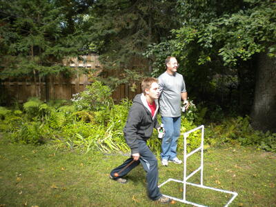 Jesse, doing the ’Saint Paul slide’ with a beer in his hand, and Mark, trying to ignore him. (Shoreview, MN: September 17, 2011)